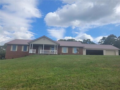 Single story home with a front lawn, a garage, and