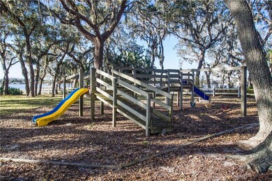 Lakefront playground nestled under shade trees