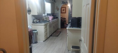 Kitchen with white cabinetry and tasteful backspla