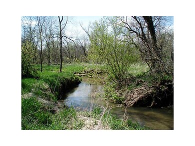 Front Exterior. Lot 8 with the creek in spring