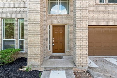 View of exterior entry featuring brick siding