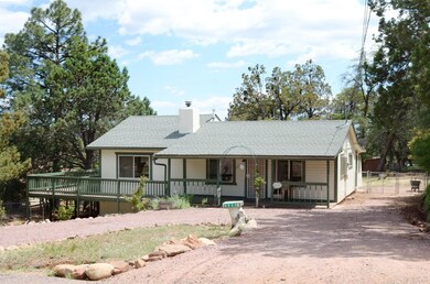 Front with driveway and deck