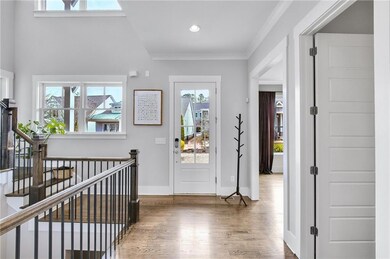 Entryway with ornamental molding and dark hardwood