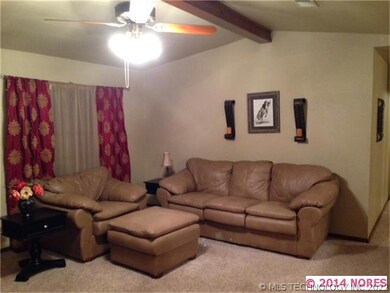 Large living room boasts vaulted ceiling, plenty o