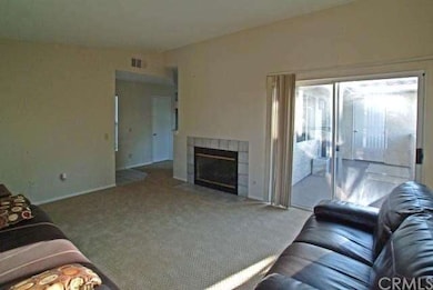 Large living area with cozy fireplace and adjacent