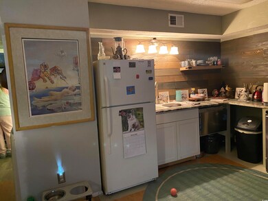 Kitchen with visible vents, wooden walls, light co
