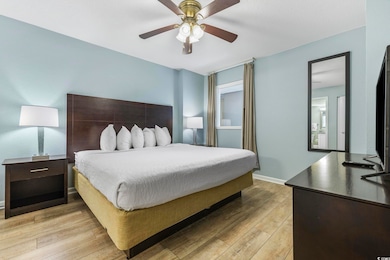 Bedroom featuring ceiling fan and light wood-type 