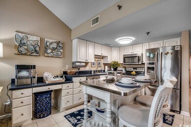 Kitchen featuring light tile patterned floors, dar