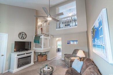 Carpeted living room with ceiling fan and a high c
