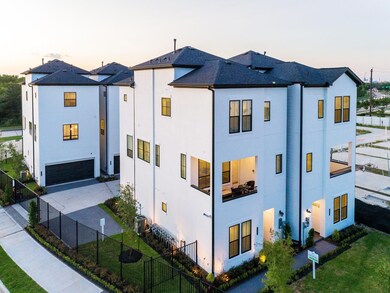 3 story high with white comtemporary stucco facia.