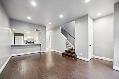 The beautifully updated kitchen seamlessly flows f