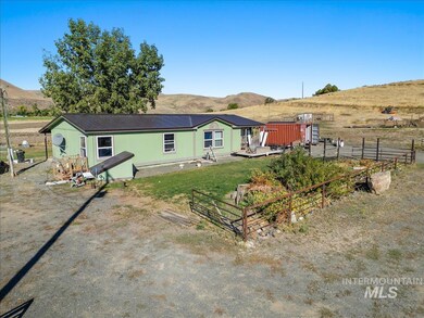Rear view of property with a mountain view, a metal roof, and a rural view