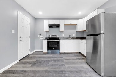 Kitchen with light wood-style floors, appliances w
