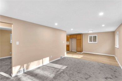 Living room is open to the dining area. New carpet