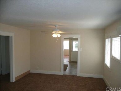 Entry to living room with dining area, ceiling fan