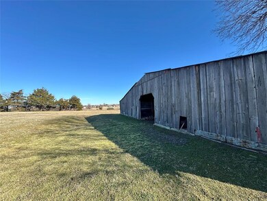 View of outbuilding with a yard and a rural view