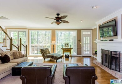Great hardwoods and fireplace in the den. The door