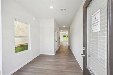 Hall featuring recessed lighting, wood finished floors, and baseboards