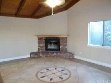 FAMILY ROOM WITH COZY CONER BRICK FIREPLACE AND HE