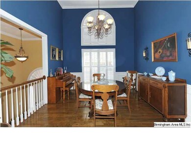 Dining room features wainscoting palladium windows