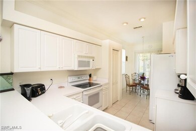 Kitchen with light tile patterned floors, crown mo