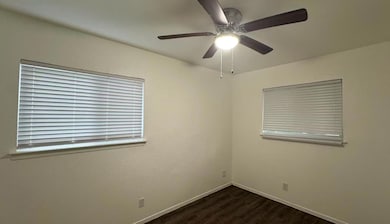 Empty room featuring ceiling fan, wood finished f