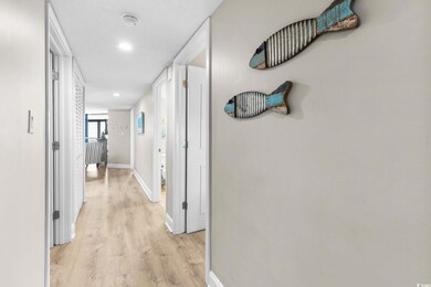 Corridor featuring baseboards and light wood finis