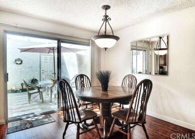 Dining area overlooking patio leading to garage