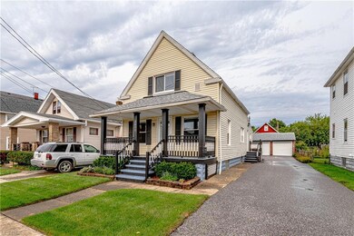 View of front of property with garage, a porch, and a front yard