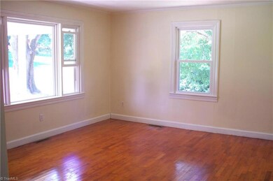 Large living room with plenty of natural light and beautiful hardwoods