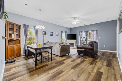 Living room featuring a glass covered fireplace, w