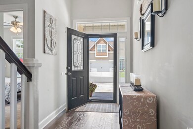 Foyer entrance featuring dark wood-style flooring and ceiling fan