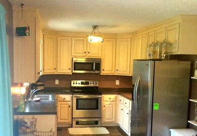 Lovely kitchen with glazed cabinets and stainless appliances...fridge can stay!