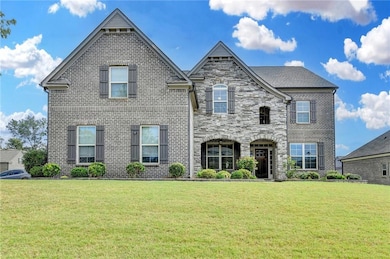 View of front of property with a front lawn and brick siding