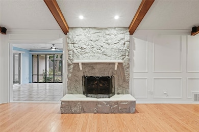 Unfurnished living room with ceiling fan, a firepl