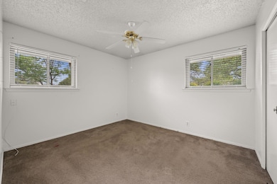 Spare room with carpet flooring, a textured ceili