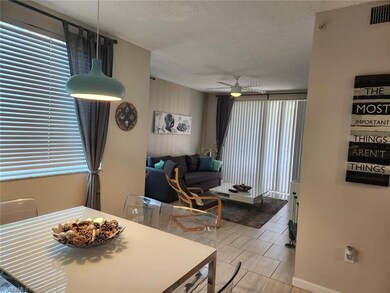 Tiled dining space with ceiling fan and a textured ceiling