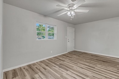 Spare room with light wood-type flooring and a ceiling fan