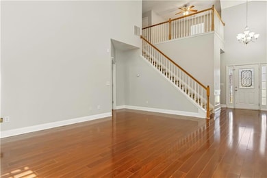 Foyer with stairway, a towering ceiling, wood fini