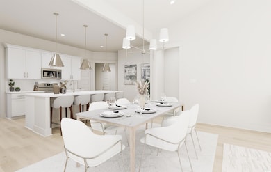 Dining area featuring sink and light wood-type flo