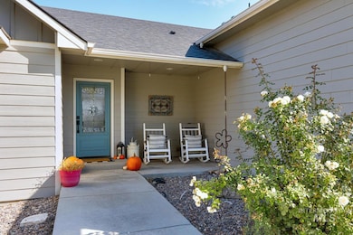 Entrance to property with roof with shingles and covered porch