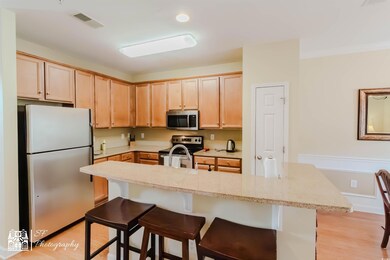 Kitchen with visible vents, light brown cabinetry,