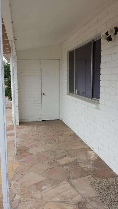 Front covered patio with garage entrance