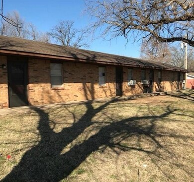 View of side of property featuring a lawn