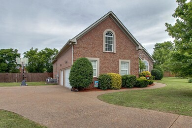 Lush landscaping accents this beautiful full brick home