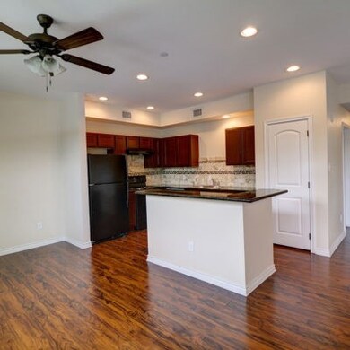 Kitchen with dark wood-type flooring, dark counter