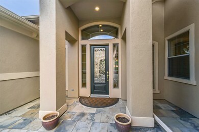 Covered Front Entry with two columns and an archwa