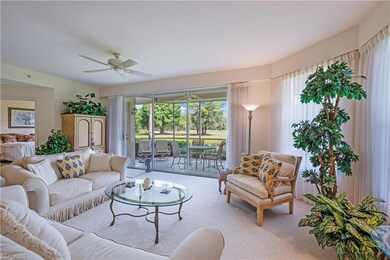 Living area with ceiling fan and light colored carpet