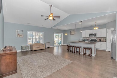 Living room with ceiling fan, light hardwood / woo