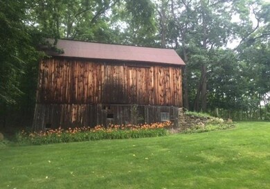 Another view of the barn, yard and flowers. Privat